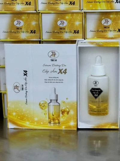 X4 Moisturizing Serum from the Tika X4 Brand, White Paper Box with Gold Design, Contains Gold Solution in a Small Bottle with a White Cap, Suitable for Daily Skin Care.
